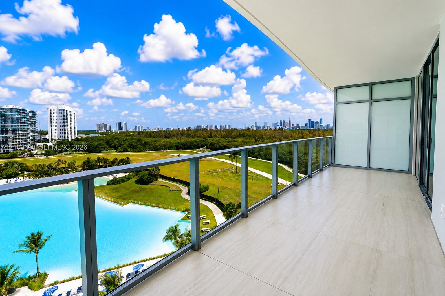 Covered balcony featuring neutral large-format tile flooring and a glass-paneled railing