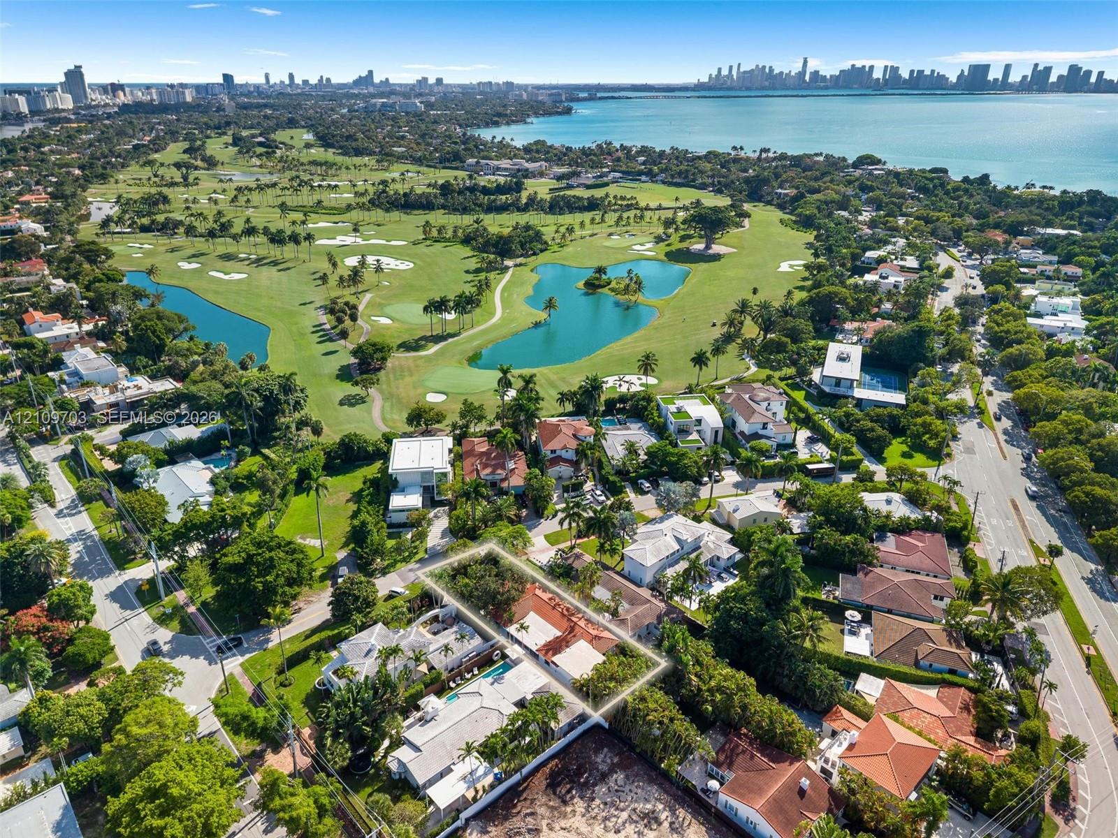 Aerial perspective of property featuring a multi-pitched roofline and mature perimeter landscaping