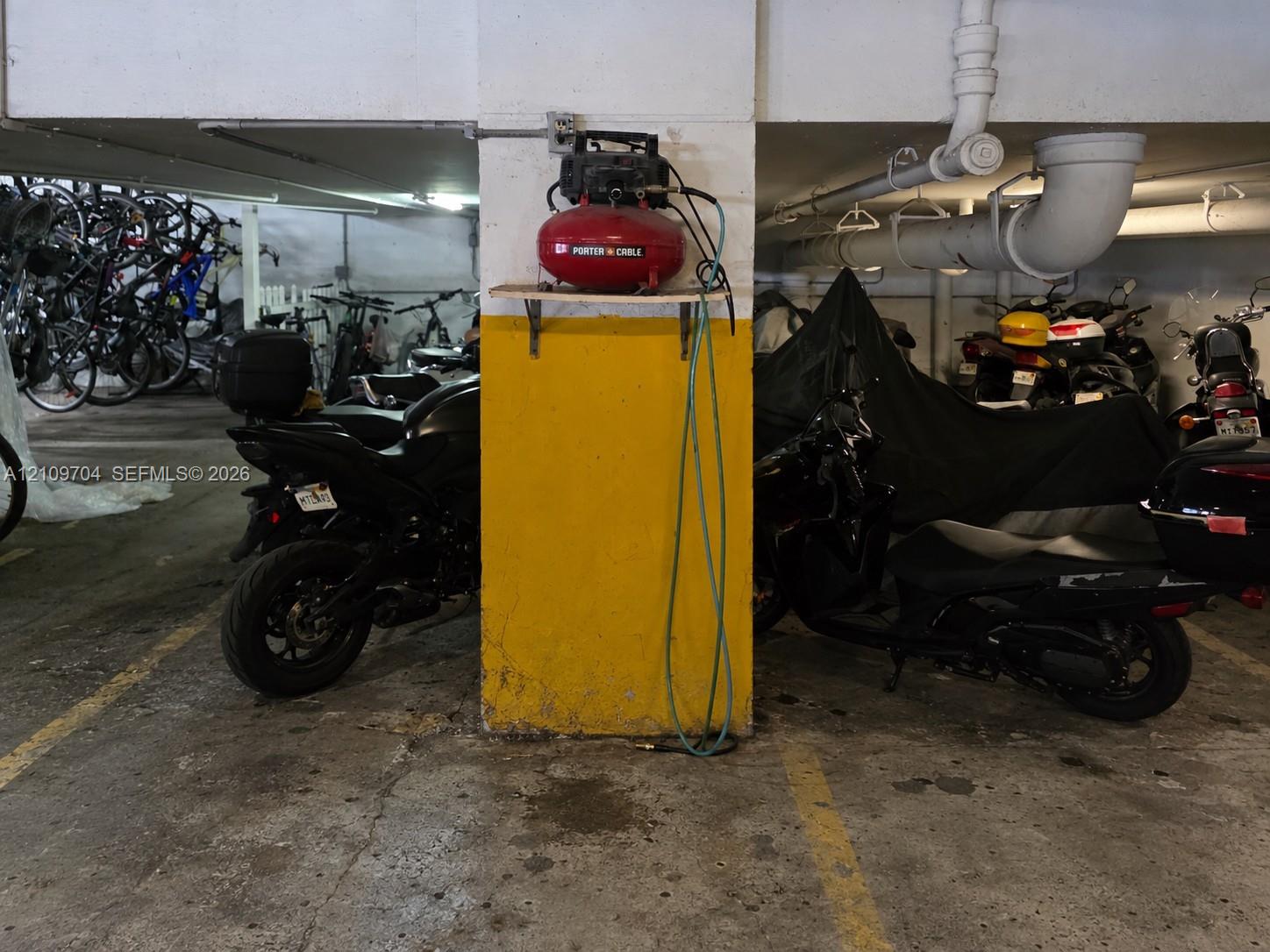 Covered parking area featuring concrete flooring and structural support columns