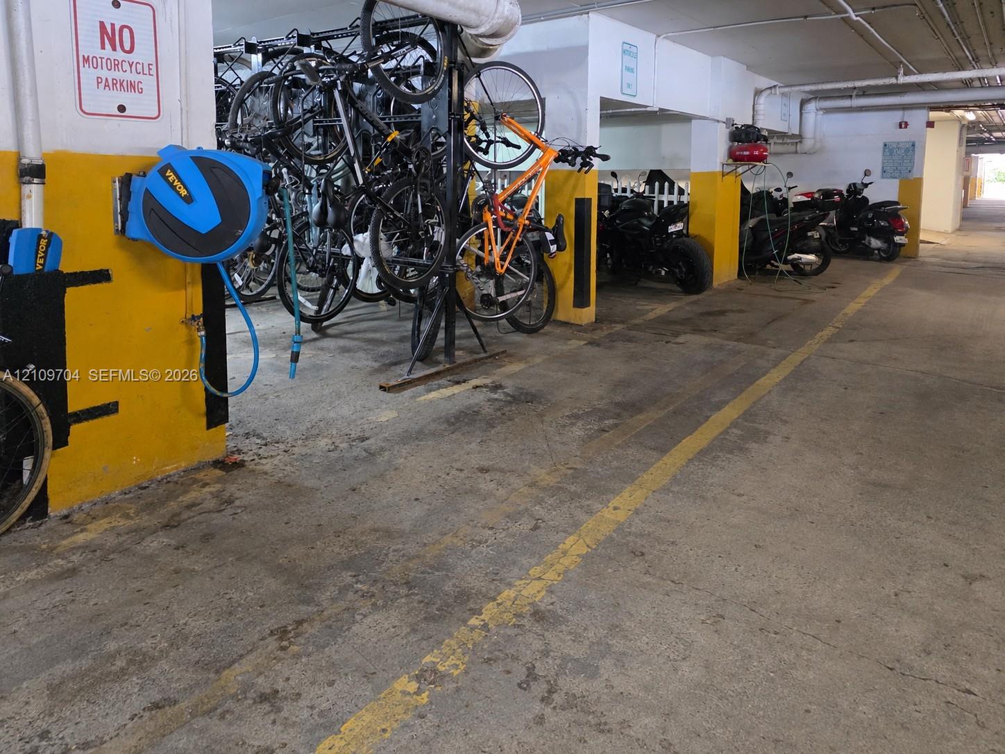 Covered parking garage featuring dedicated bicycle storage racks and painted floor markings
