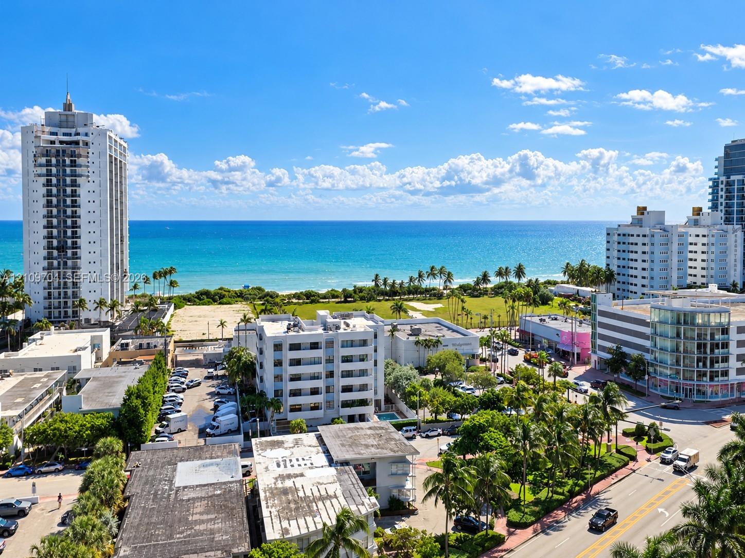 High-rise aerial perspective featuring expansive ocean exposure, proximity to coastal shoreline, and urban landscape with mature palm trees