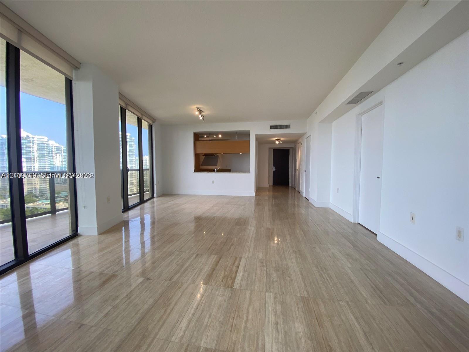 Open floor plan, floor-to-ceiling windows.