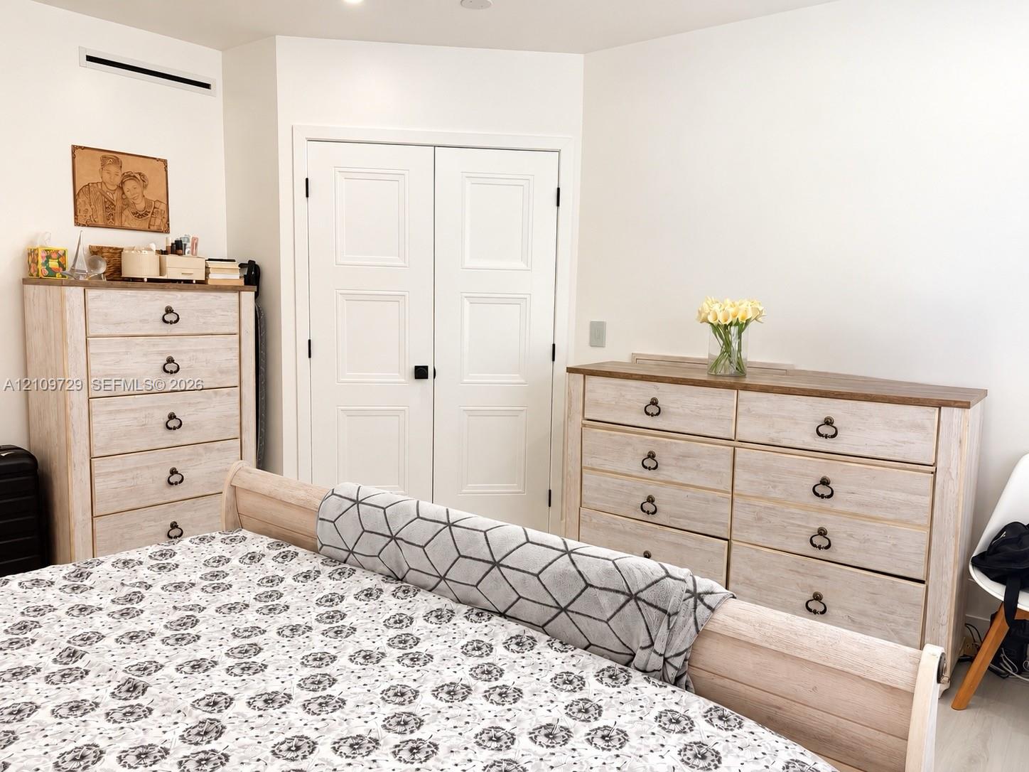 Double-door closet with recessed panels and matte black hardware