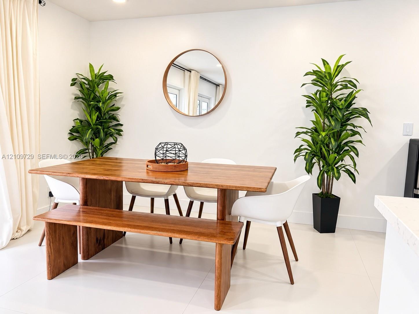 Neutral-toned space featuring white flooring, crisp white walls, and a recessed ceiling light