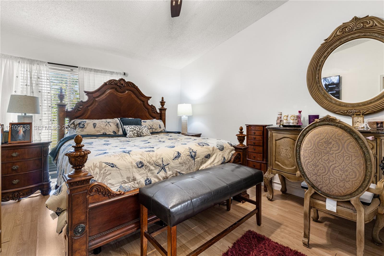 Wood-finish flooring, ceiling fan, and window blinds Wood-finish flooring, ceiling fan, and window blinds
