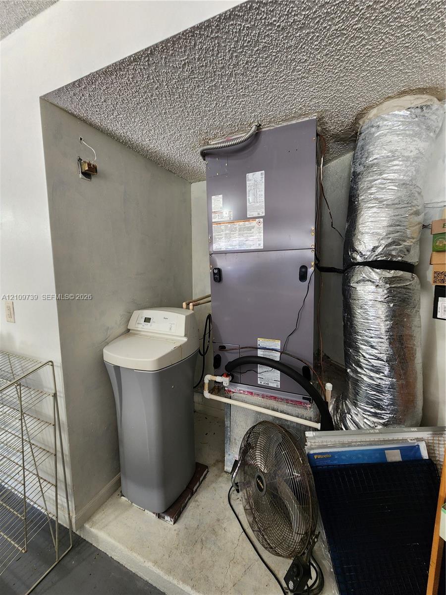 Mechanical area featuring a climate control air handler unit and a water softening system