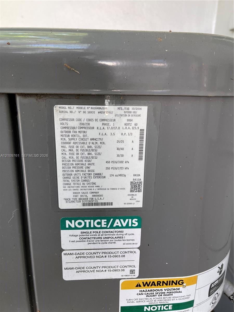 Outdoor heating and cooling unit featuring a durable grey enamel finish, factory-specified technical data plate, and Miami-Dade County product control certification