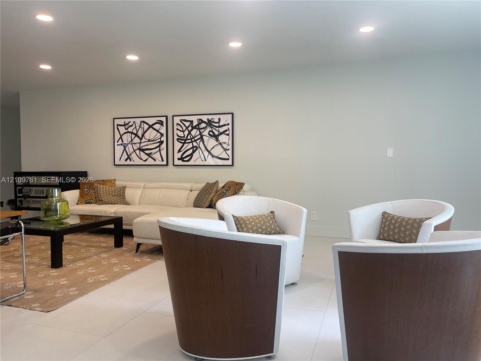 Neutral-toned interior featuring large-format tile flooring and recessed ceiling lighting Neutral-toned interior featuring large-format tile flooring and recessed ceiling lighting