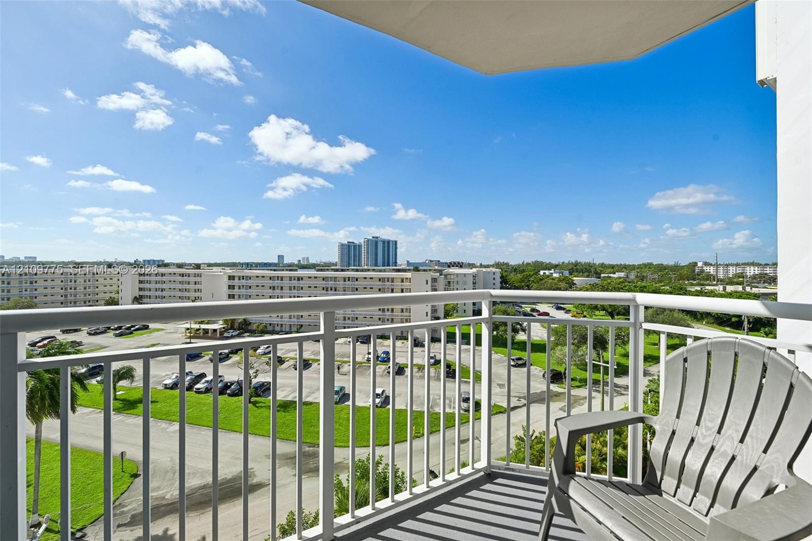 Private balcony with white metal railings and concrete flooring