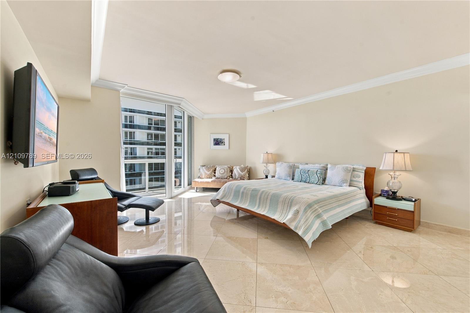 Polished stone flooring, crown molding, and floor-to-ceiling windows featuring a glass balcony enclosure