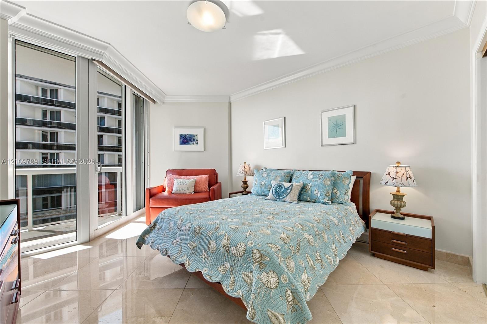 Floor-to-ceiling glass panel door, polished stone tile flooring, crown molding, and recessed ceiling lighting