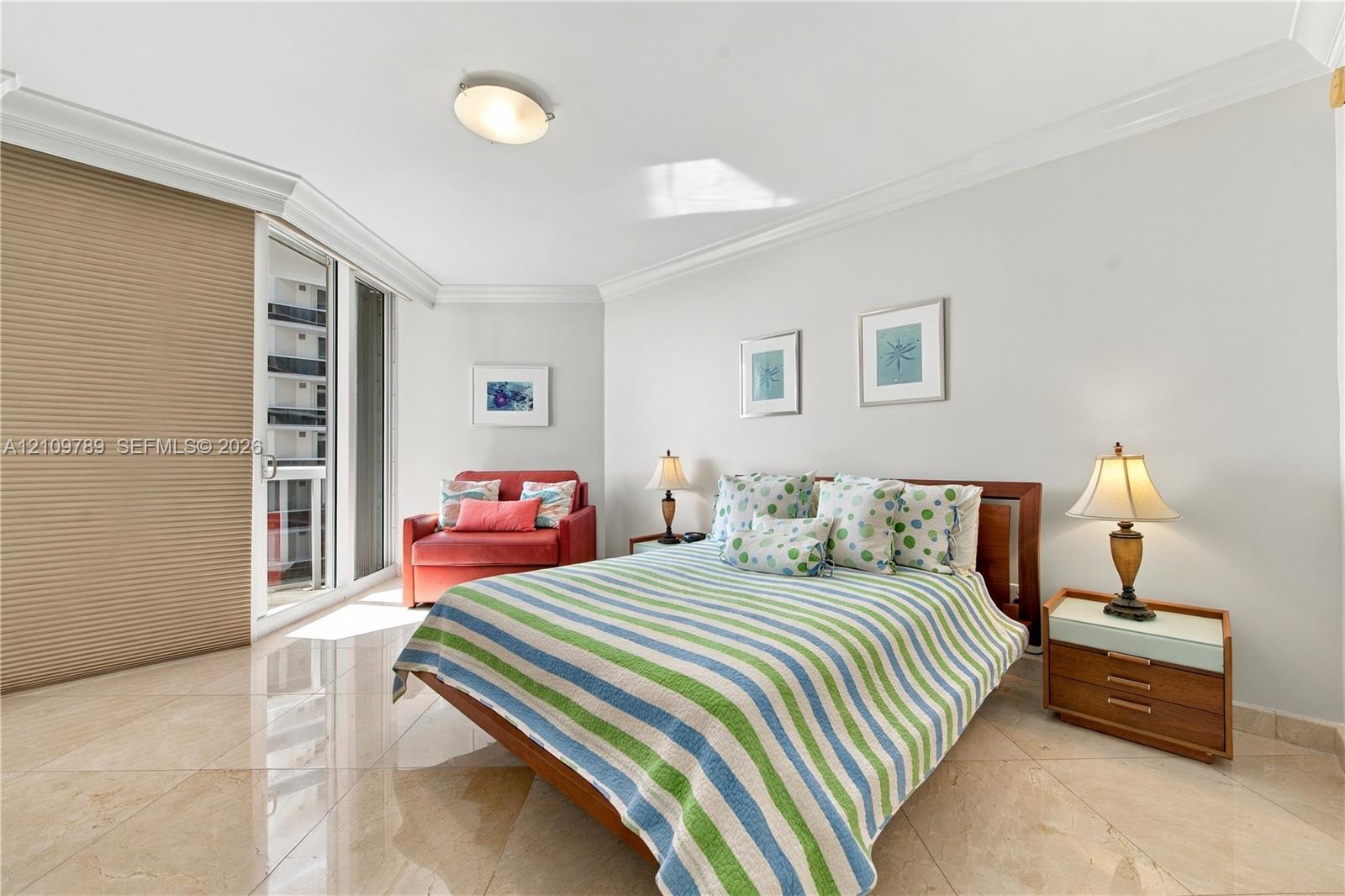 Neutral stone-finish flooring, crown molding, floor-to-ceiling glass sliding door, and recessed ceiling lighting