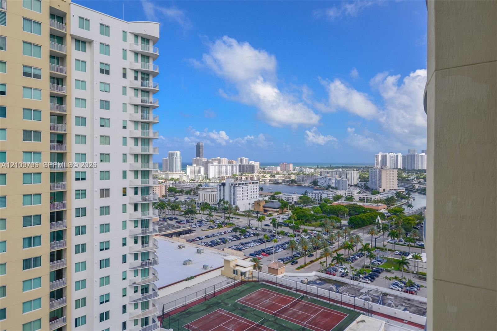 High-rise urban outlook featuring dual tennis courts, expansive skyline exposure, and coastal proximity High-rise urban outlook featuring dual tennis courts, expansive skyline exposure, and coastal proximity