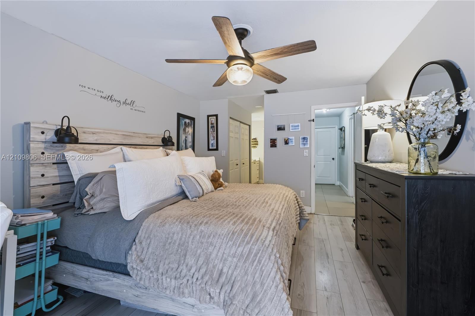 Wood-finish flooring, ceiling fan with integrated lighting, and dual-door closet