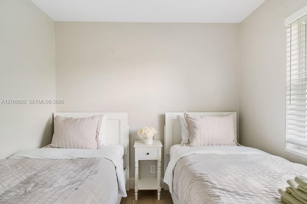 Neutral wall palette, wood-finish flooring, and horizontal window blinds