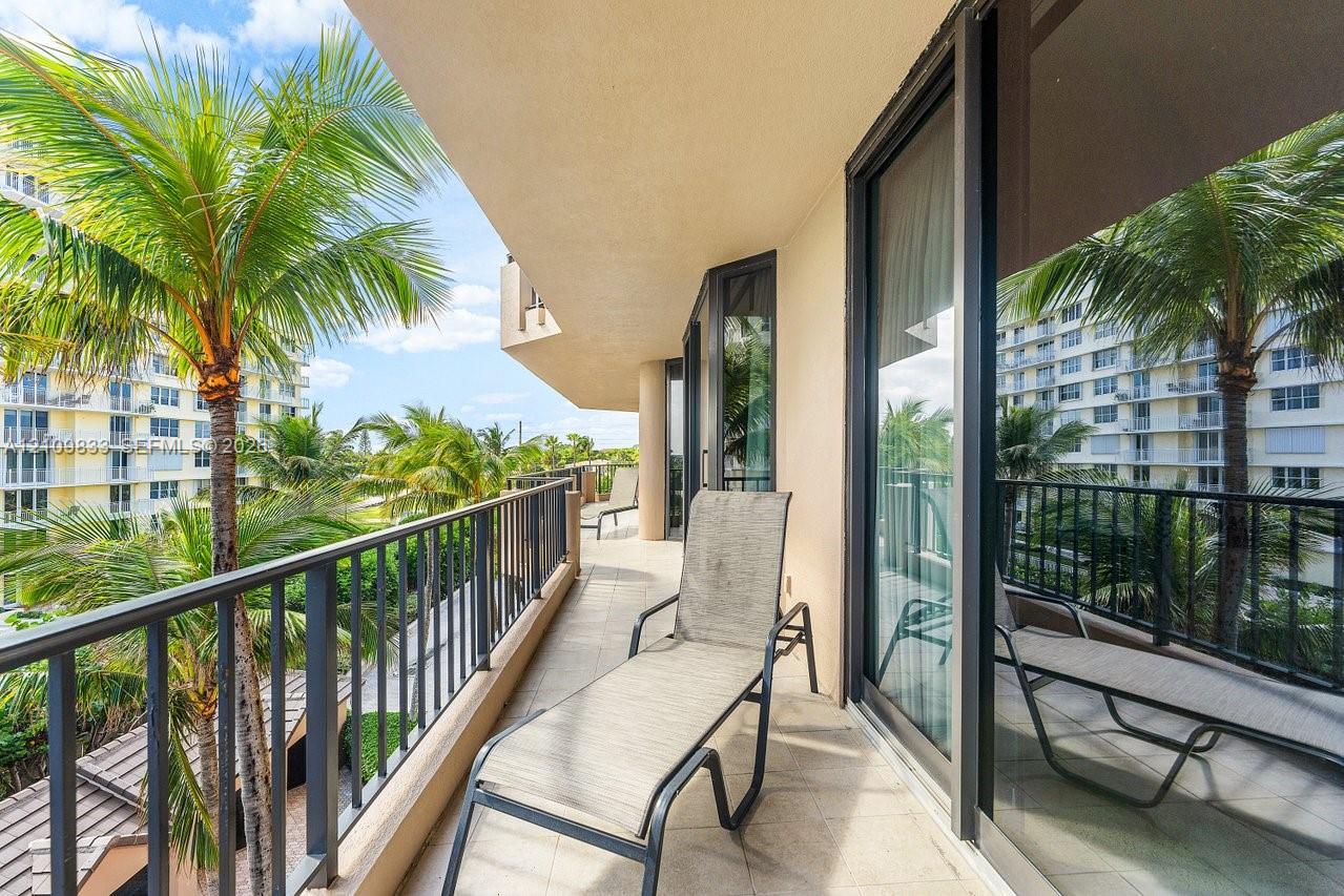 Covered balcony featuring tile flooring and dark metal railing