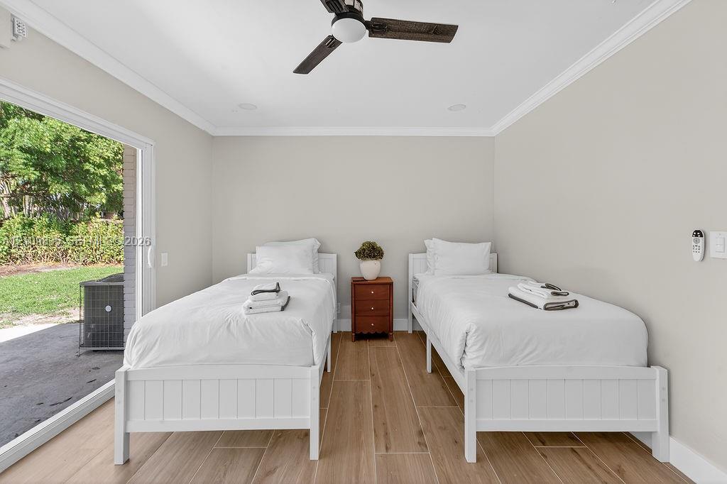 Room featuring wood-finish tile flooring, a neutral color palette, recessed lighting, a modern ceiling fan, and a large sliding glass door