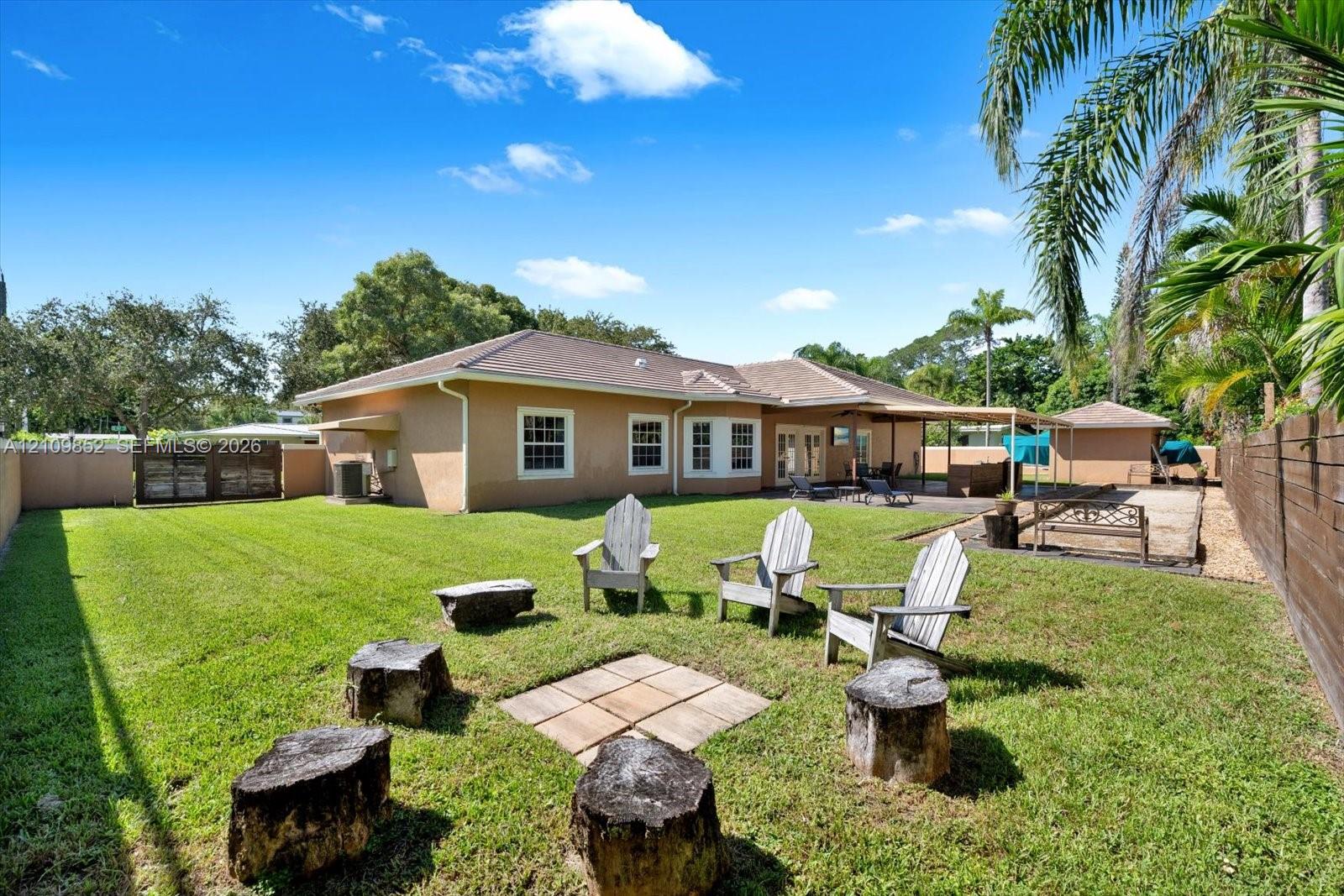 Expansive & private backyard featuring a manicured lawn and the dedicated space for entertaining with a fire pit * Owners paid extra to have the utility lines buried underground *