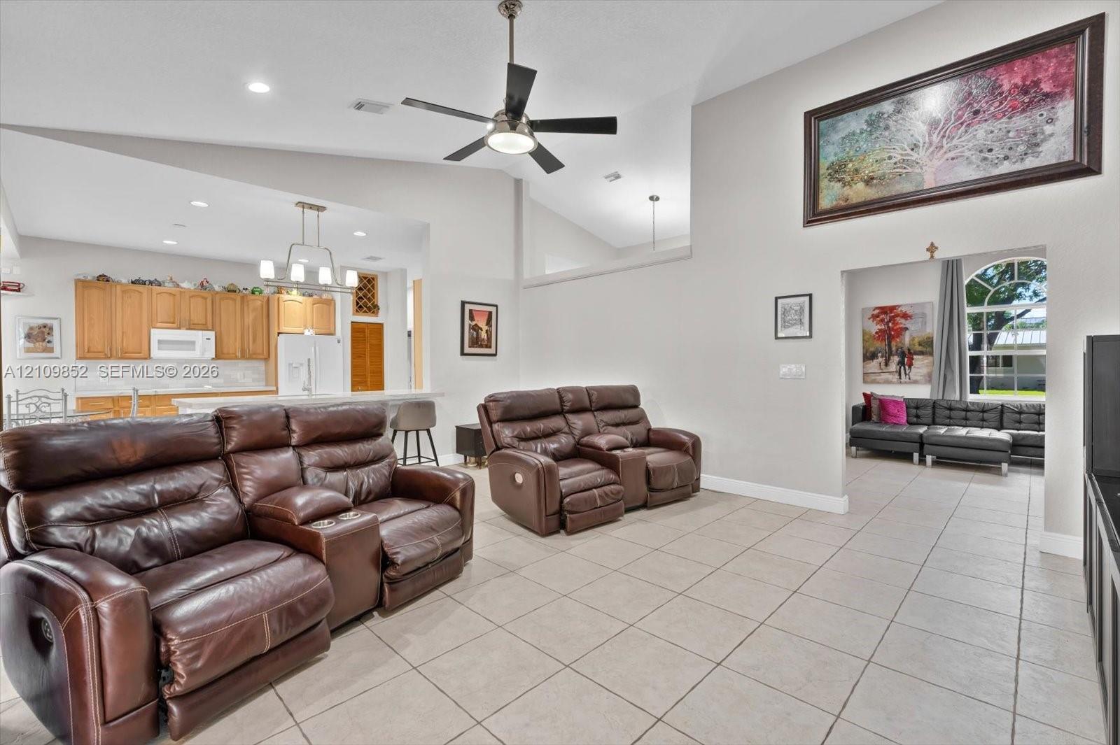 Another view of the family room with the kitchen in the background