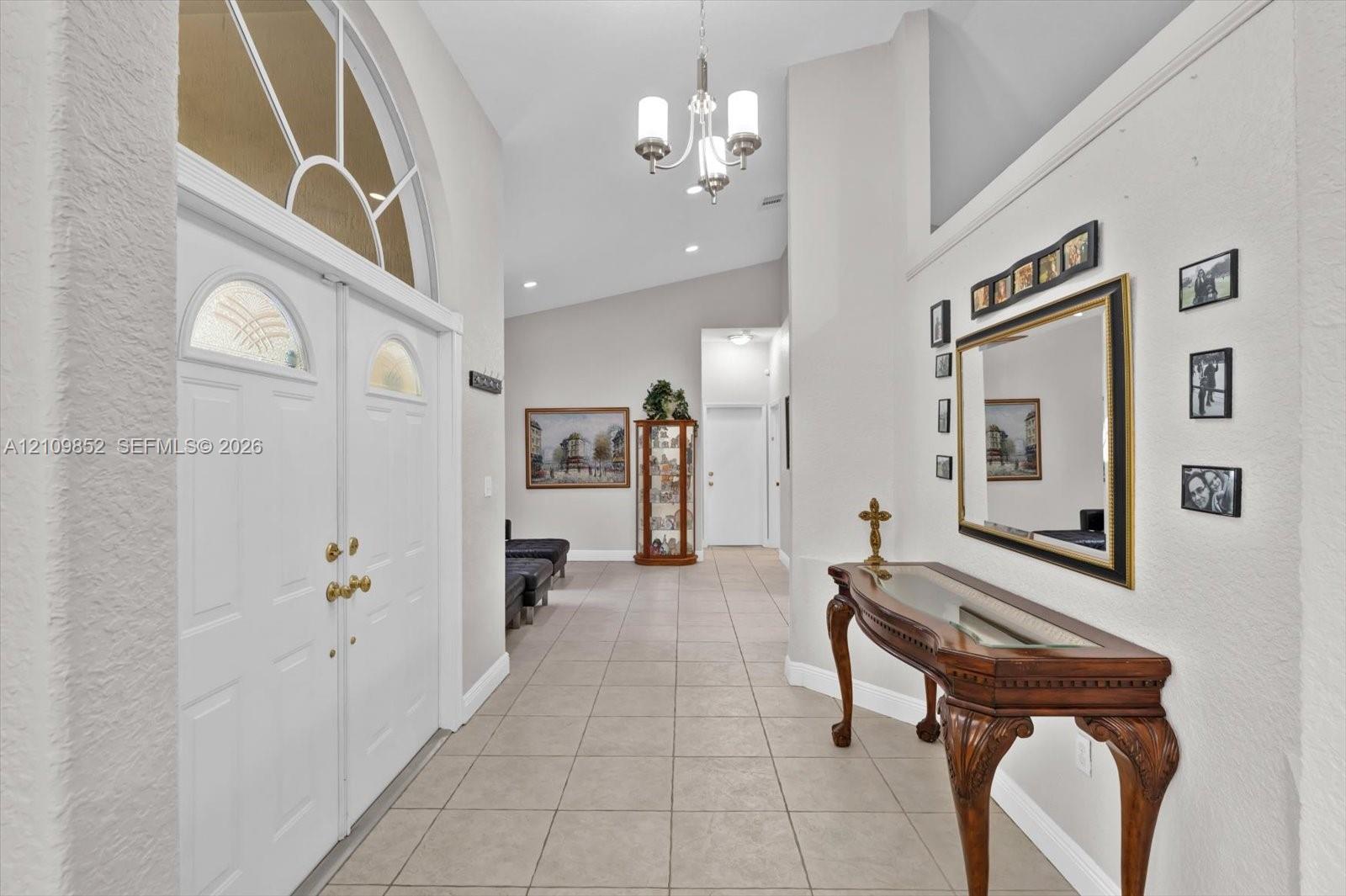 Foyer featuring double entry doors with arched glass inserts *