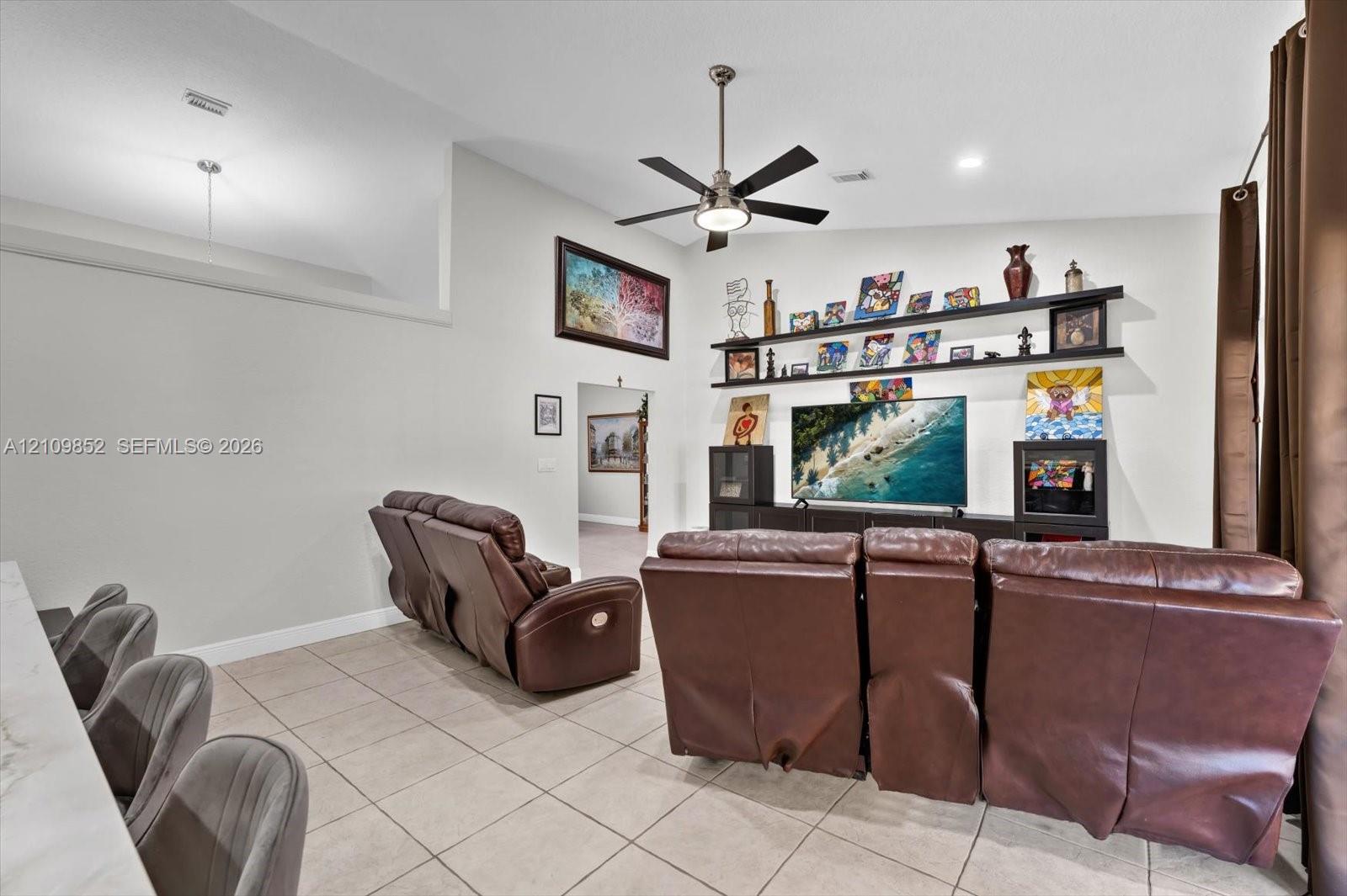 Adjoining the kitchen is an oversized family room with volume ceilings and french doors leading to the covered patio and backyard *