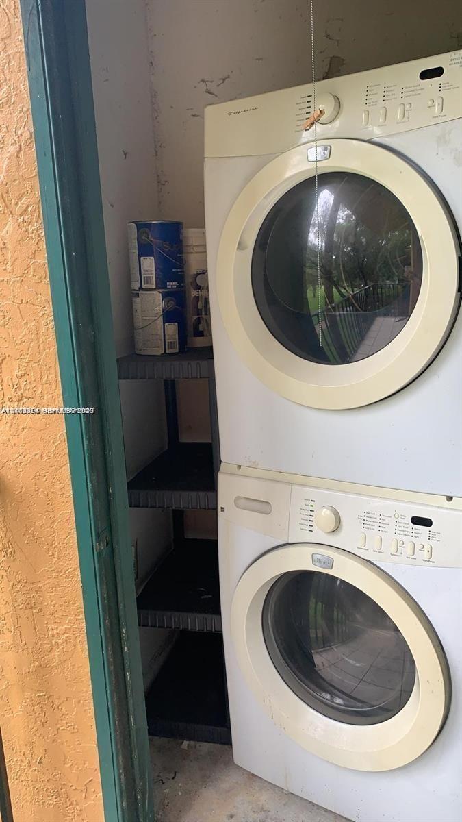 Stacked front-loading washer and dryer unit with integrated control panels