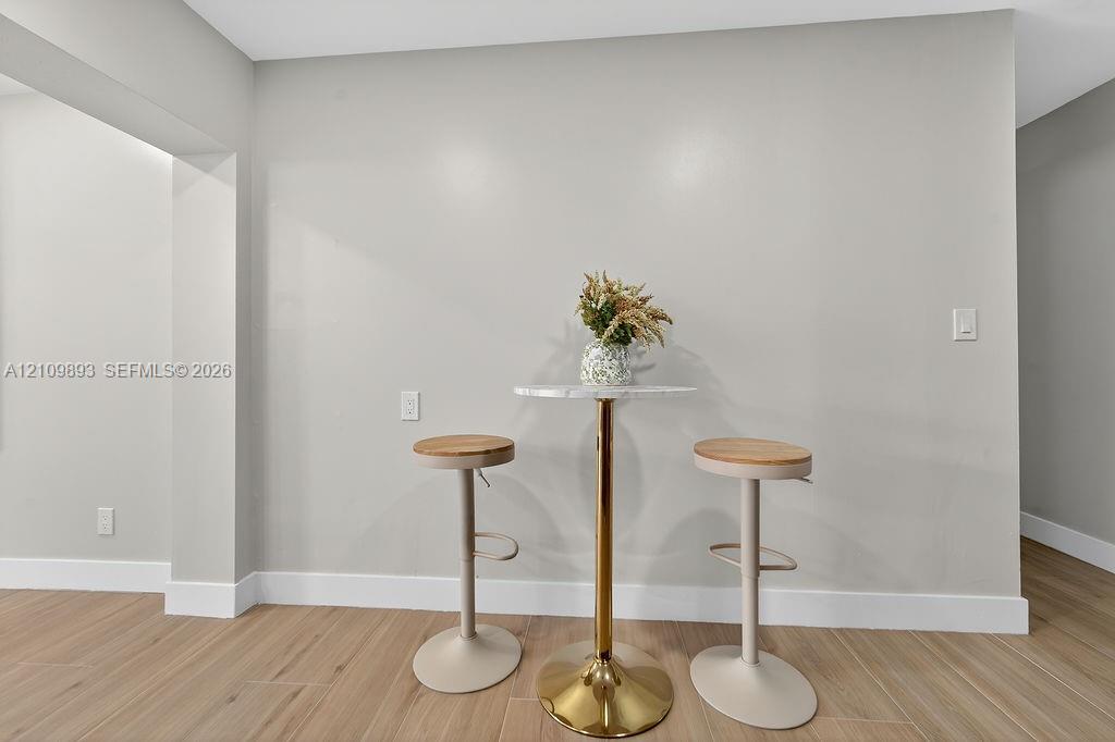 Neutral wall tones paired with wood-finish flooring
