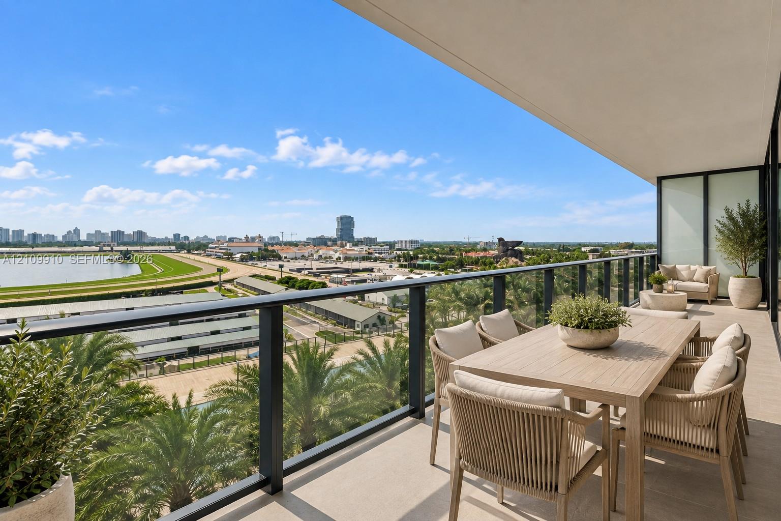 Covered balcony featuring neutral tile flooring, a sleek black metal railing with glass panels, and an expansive cityscape horizon