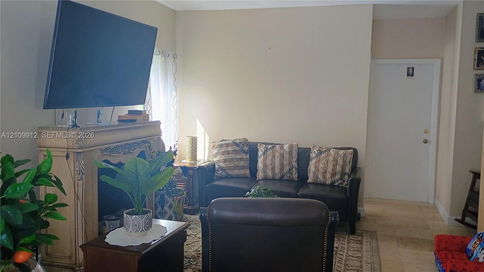 Fireplace featuring decorative molding and stone-tile flooring