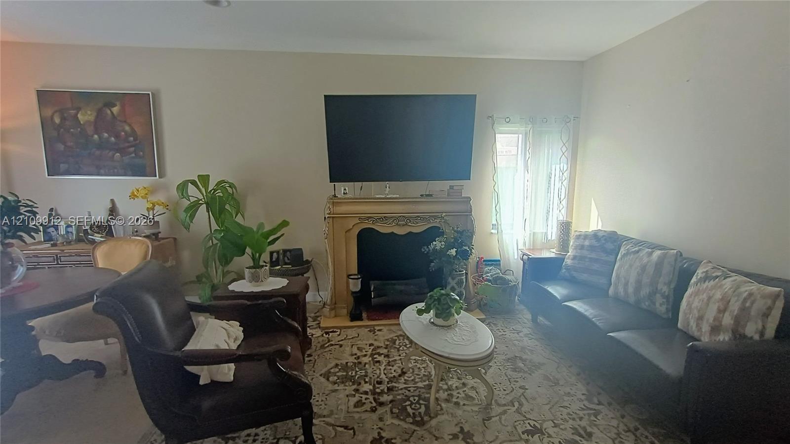 Ornate fireplace mantle with decorative carved detailing and recessed firebox