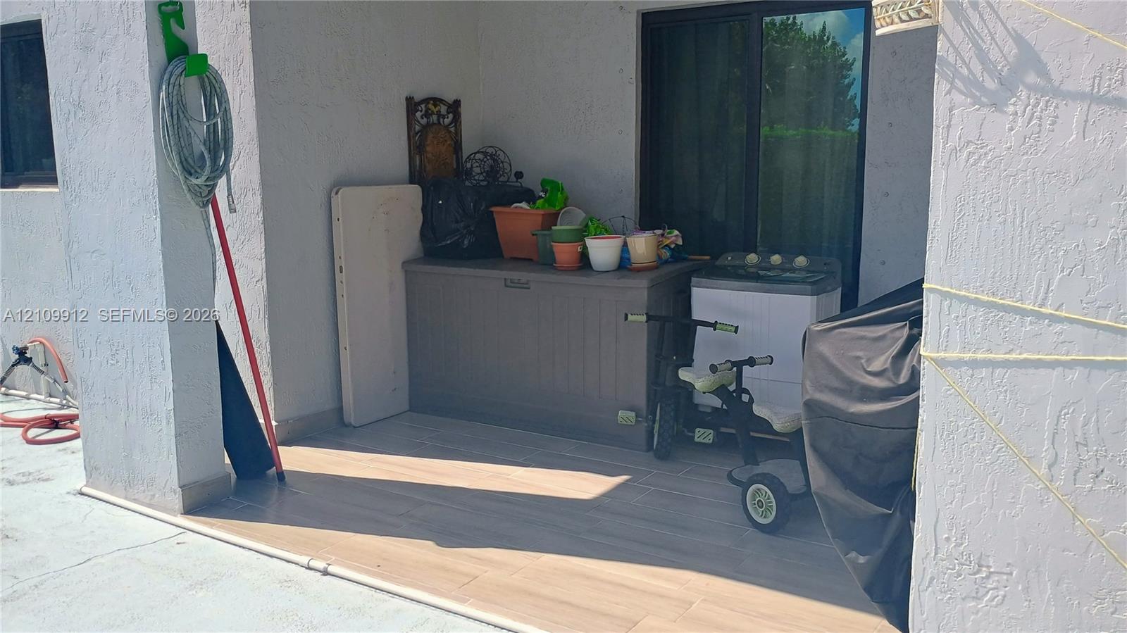 Covered patio featuring wood-finish flooring and sliding glass entry doors