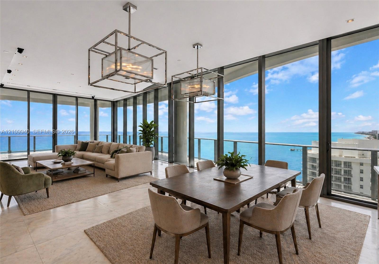 Floor-to-ceiling glass walls, polished stone flooring, and dual oversized geometric pendant light fixtures