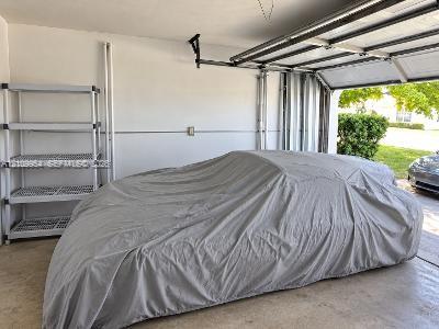 Enclosed garage space featuring a concrete floor, painted walls, and an overhead door track system