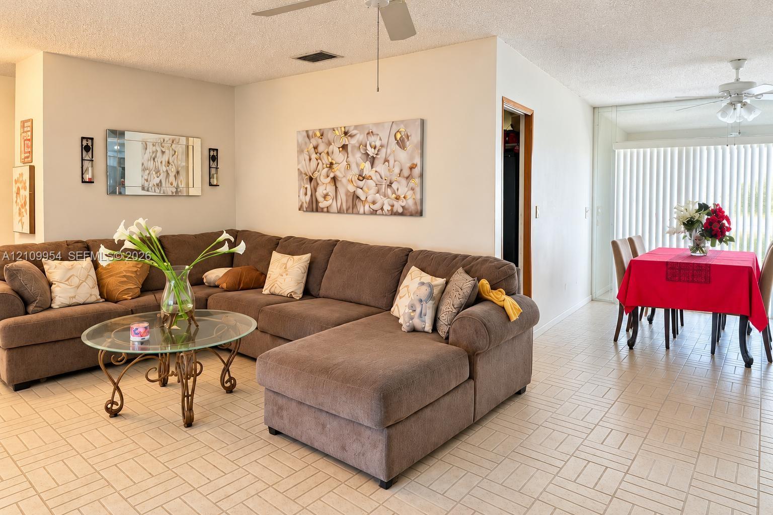 Ceramic tile flooring, dual ceiling fans with light fixtures, and floor-to-ceiling vertical blinds Ceramic tile flooring, dual ceiling fans with light fixtures, and floor-to-ceiling vertical blinds