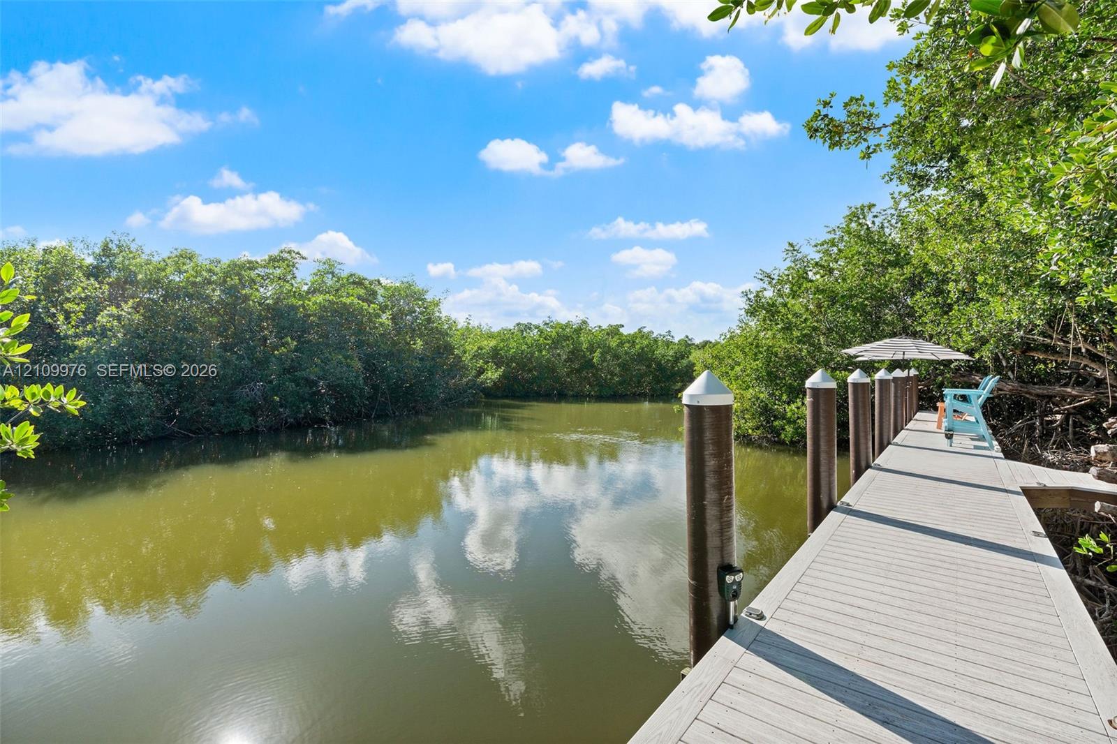 Waterfront dock featuring composite decking and anchored mooring pilings
