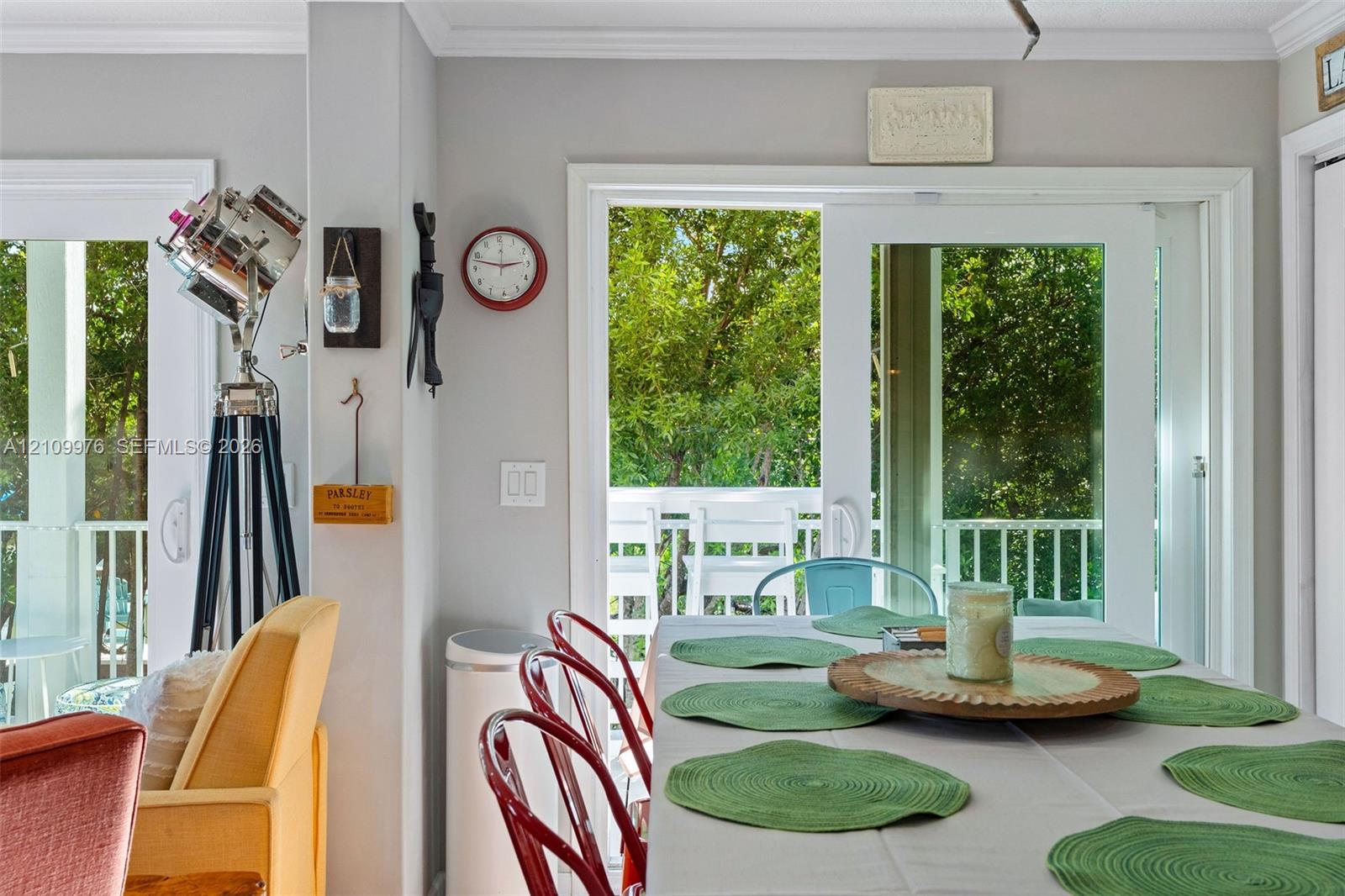 Dual sliding glass doors with white frames providing exterior access and a white railing balcony