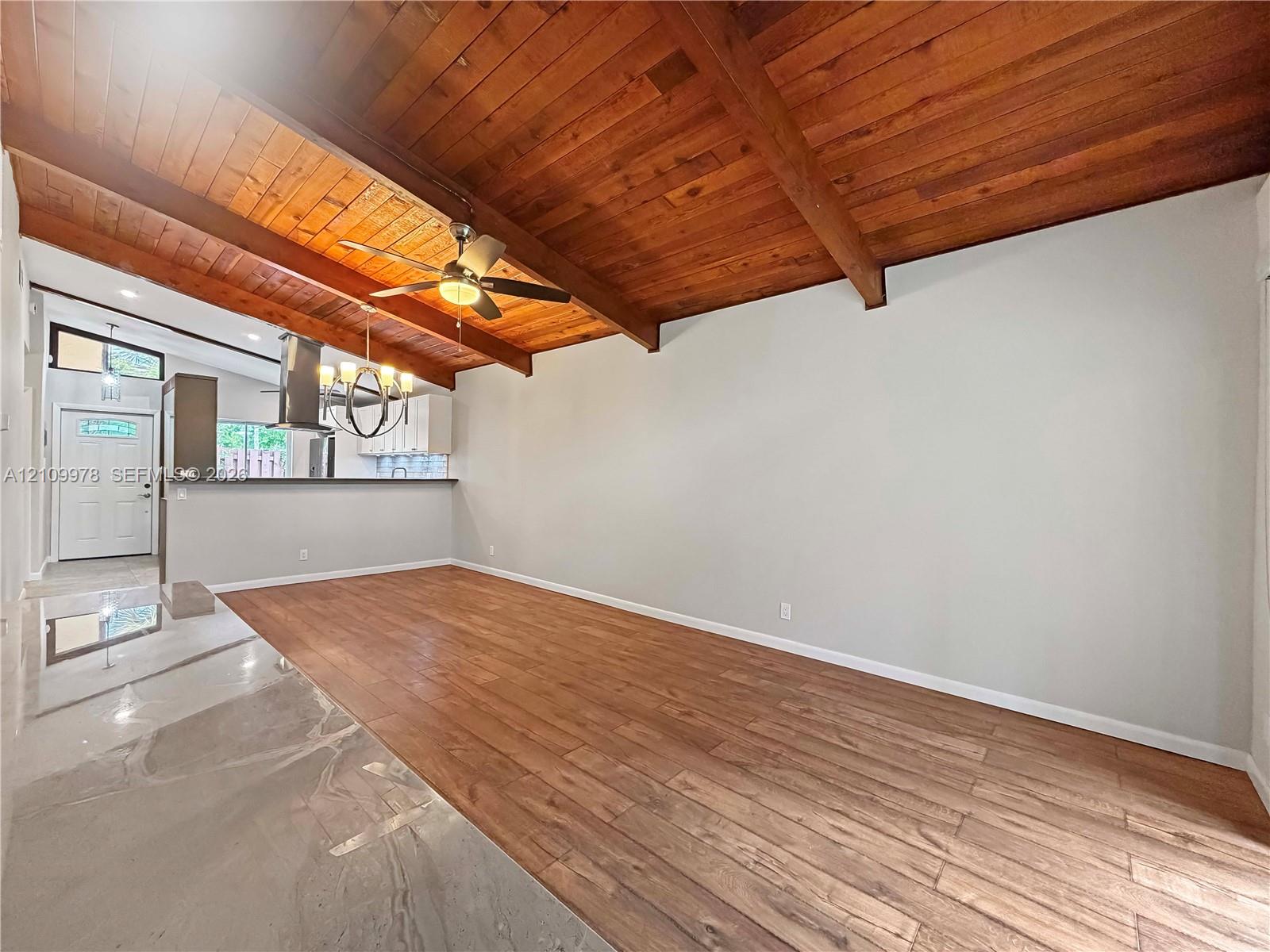 Vaulted ceiling featuring exposed wood beams and wood-plank ceiling finish, wood-finish flooring, and recessed lighting Vaulted ceiling featuring exposed wood beams and wood-plank ceiling finish, wood-finish flooring, and recessed lighting