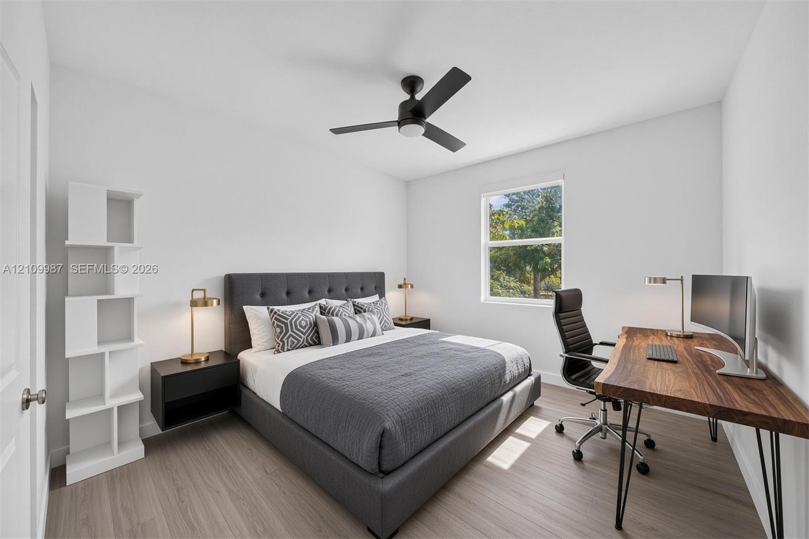 Staged Bedroom featuring porcelain flooring, a matte black ceiling fan with integrated lighting, and a single-pane window