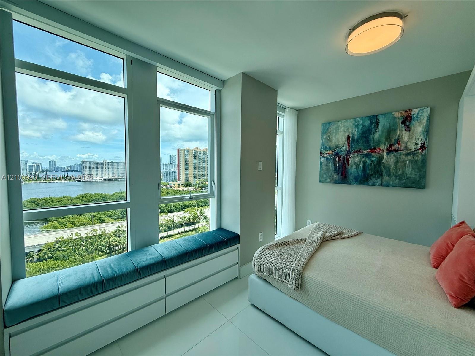 Floor-to-ceiling windows, built-in window seating with integrated cabinetry, polished tile flooring, and flush-mount ceiling lighting