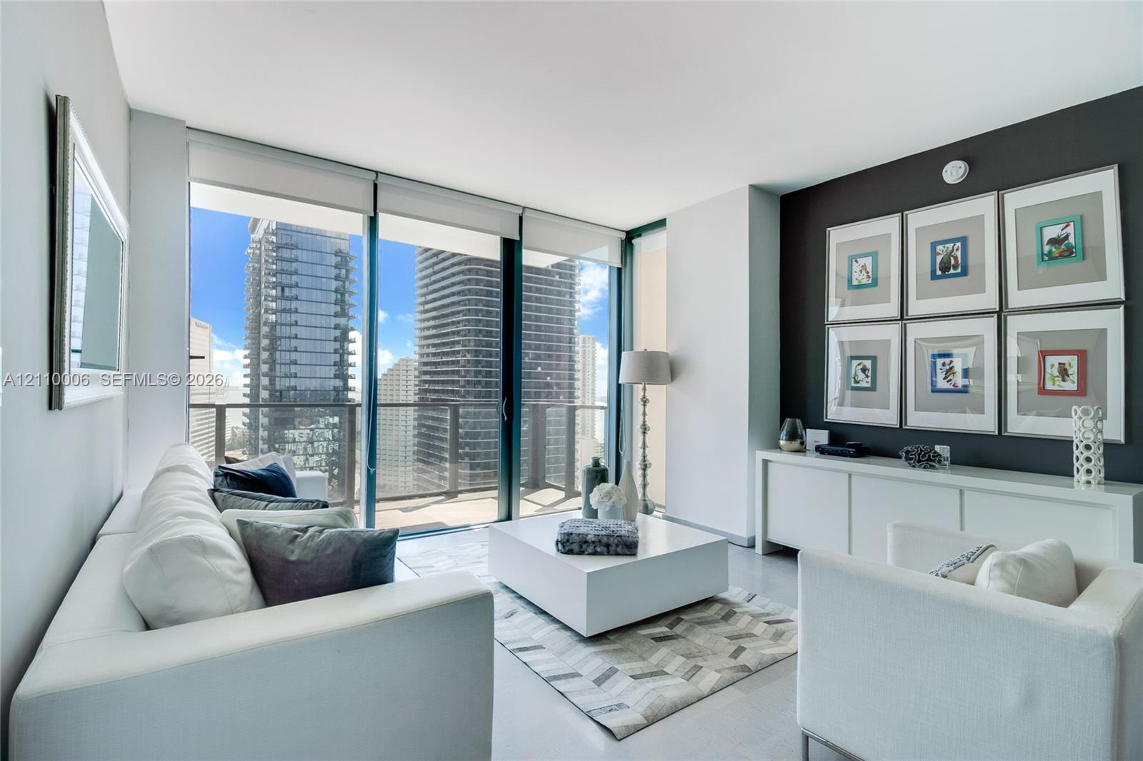 Floor-to-ceiling glass walls, balcony access, neutral wall tones, and built-in minimalist cabinetry