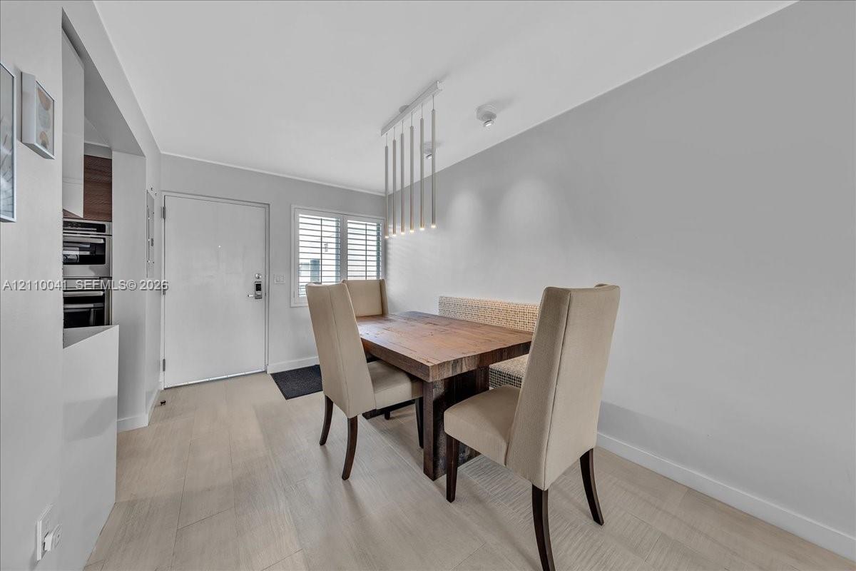 Wood-finish flooring, multi-pendant linear light fixture, and window shutters