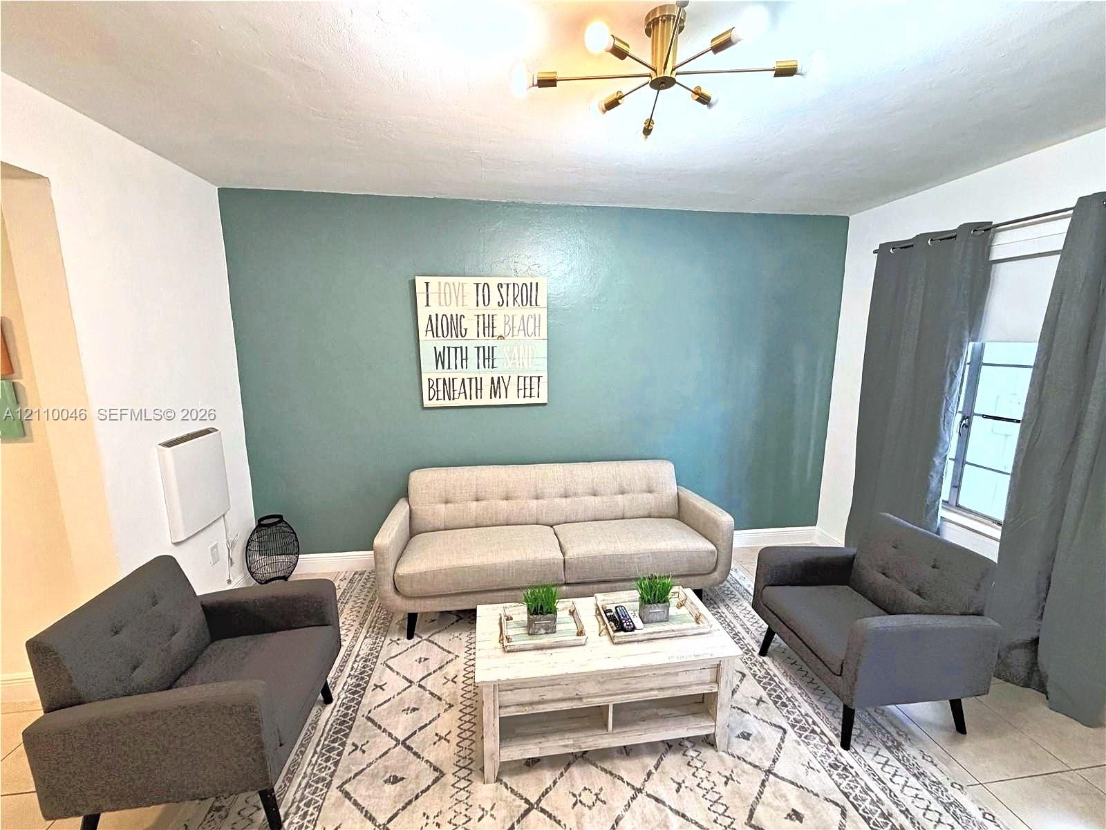 Multi-arm sputnik-style ceiling light fixture, tile flooring, and accent wall