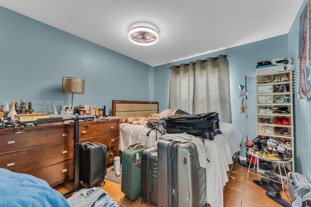 Wood-finish flooring and a contemporary circular flush-mount ceiling fan