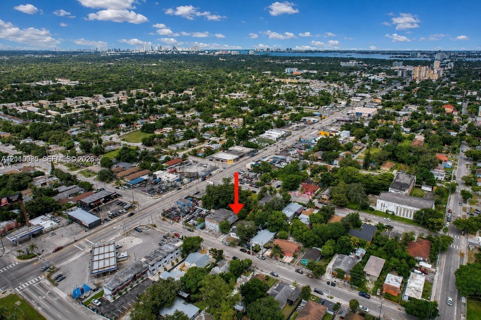 Aerial perspective of urban property location featuring extensive surrounding infrastructure and proximity to coastal water bodies