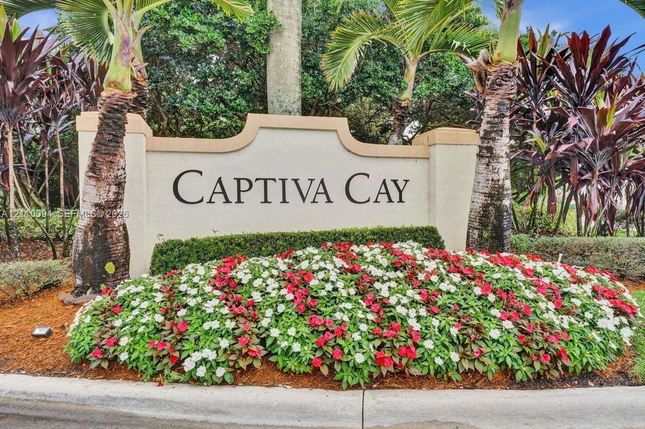 Stucco monument signage featuring professional lettering surrounded by manicured tropical landscaping, palm trees, and colorful floral beds Stucco monument signage featuring professional lettering surrounded by manicured tropical landscaping, palm trees, and colorful floral beds