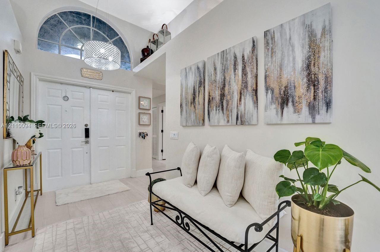 Entryway featuring high ceilings, double entry doors, and a semi-circular transom window