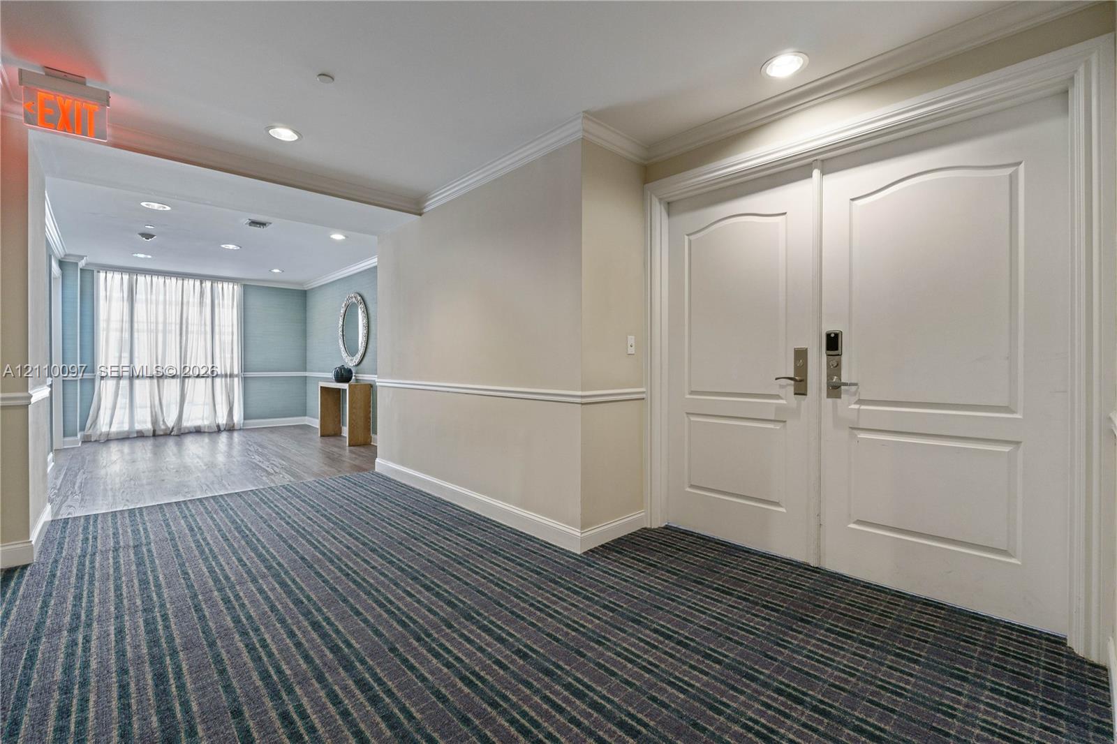 Double-door entry featuring paneled millwork, crown molding, and recessed lighting Double-door entry featuring paneled millwork, crown molding, and recessed lighting