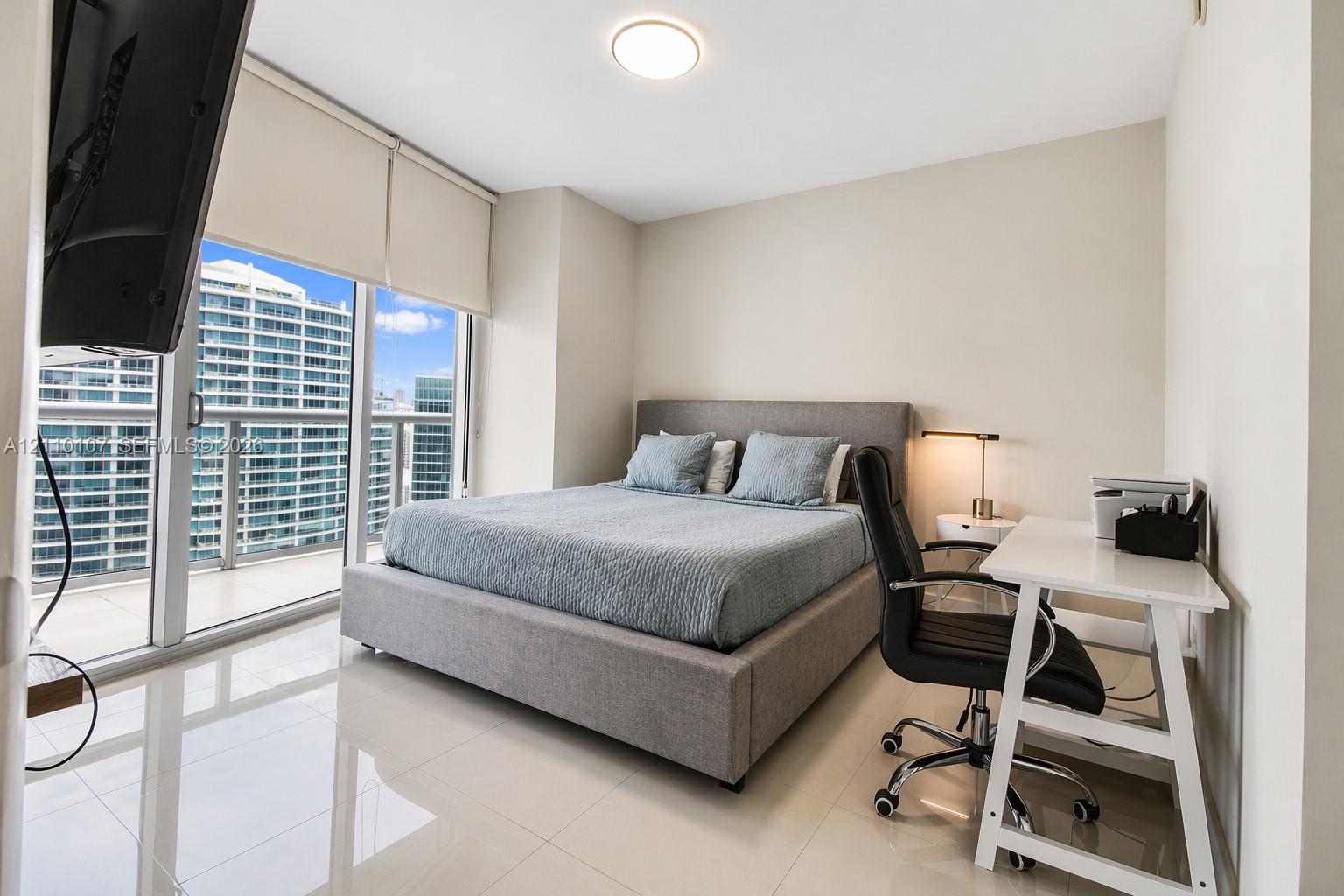 Floor-to-ceiling glass doors, neutral tile flooring, recessed ceiling lighting