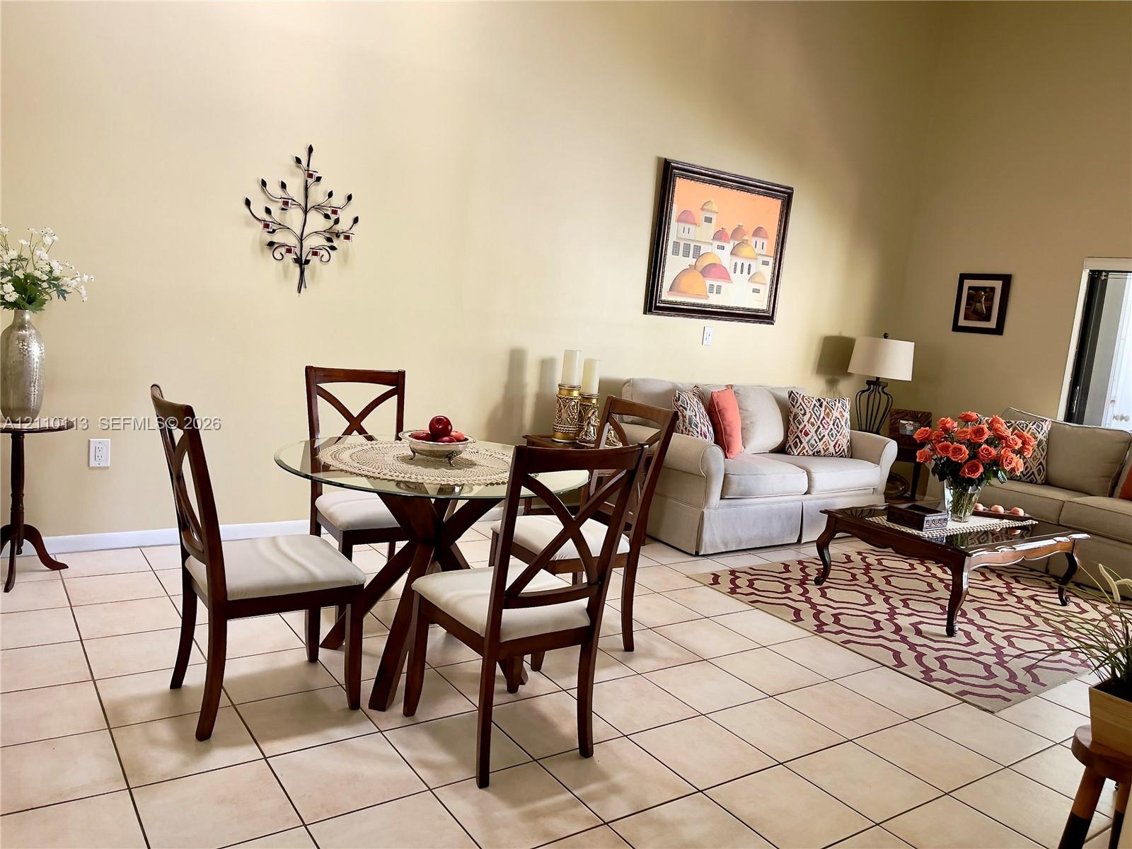 High ceilings and neutral ceramic tile flooring