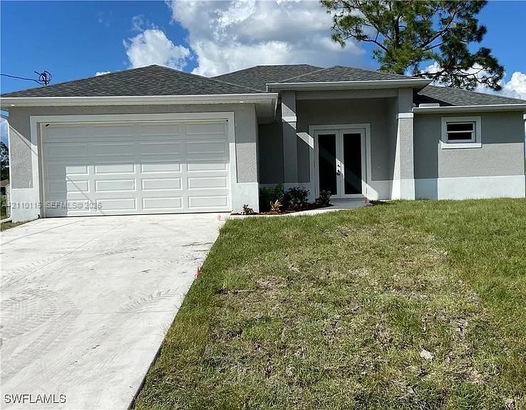 Single-story exterior featuring a stucco facade, double-door entry, concrete driveway, and a two-car garage
